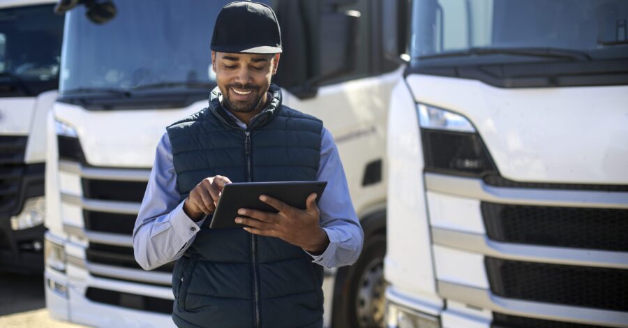 Truck driver using a tablet. About 35 years old, African male.