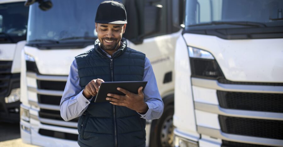 Truck driver using a tablet Truck driver using a tablet. About 35 years old, African male.
