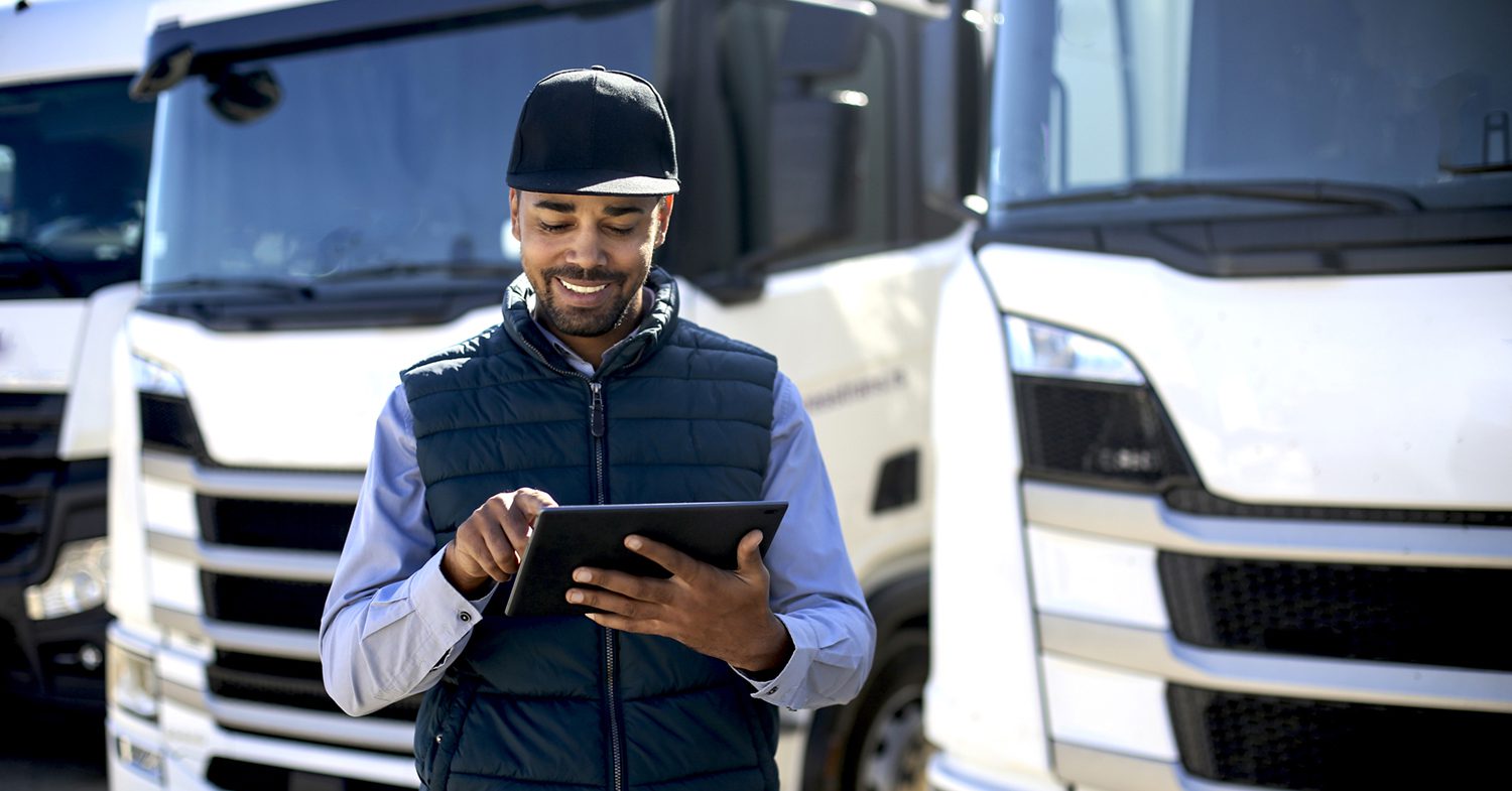 Truck driver using a tablet Truck driver using a tablet. About 35 years old, African male.