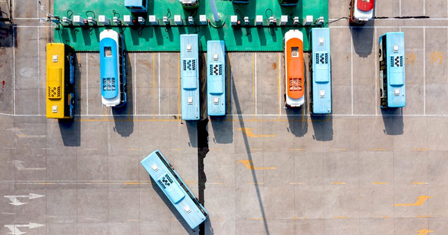 Row of buses parked at the bus terminal, high angle top view
